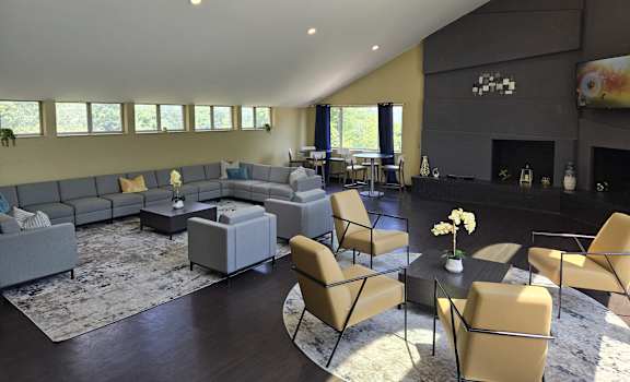 a large living room with couches and chairs and a fireplace