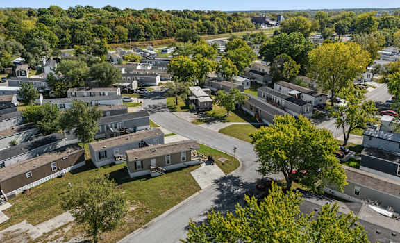 A bird's eye view of a residential area with houses and trees.