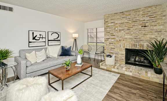 a living room with a couch and a fireplace at Peaks at Northwest Hills Apartments, Austin