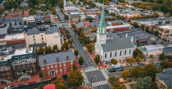 A city street with a church in the background.