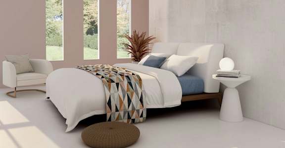 a bedroom with a bed and a chair and a table