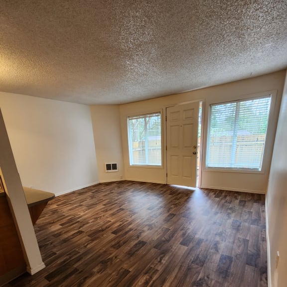 a view from the top of the stairs looking down into the living room