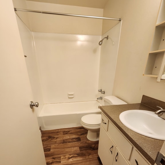 a bathroom with a toilet sink and shower
