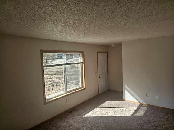 A room with a window and a door.
