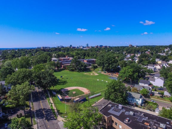 an aerial view of a park with a city in the background