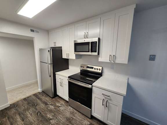 a kitchen with a sink and a stove and a refrigerator
