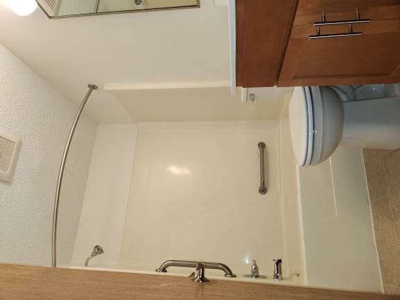 a kitchen with a sink and a faucet in the corner of a room