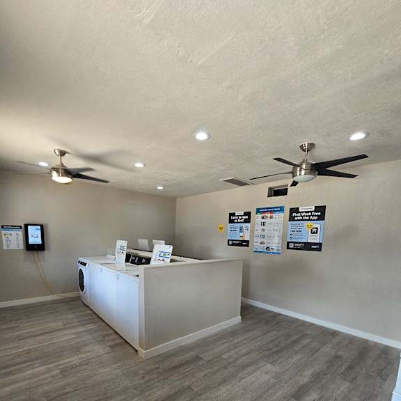 A ceiling fan hangs over a white box with a digital display.