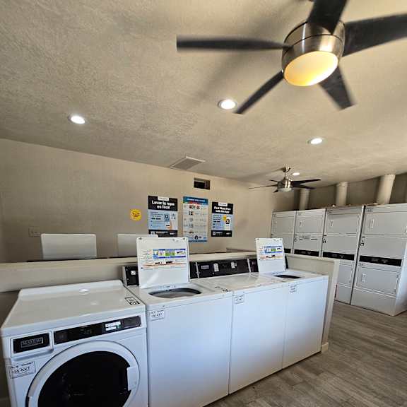 A washing machine is on top of a dryer in a small room.