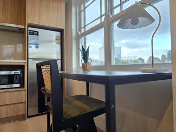A modern kitchen with a table and a chair.