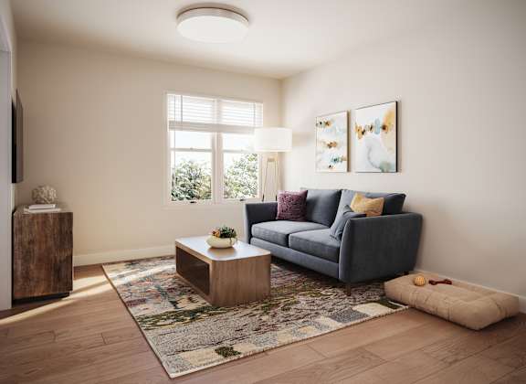 A living room with a grey couch, a wooden side table, and a rug. at Bretton Woods II Apartments, Ohio, 43231