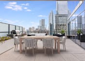 Thumbnail 12 of 47 - a communal terrace with a table and chairs and a view of the city at Cassidy on Canal, Chicago, Illinois