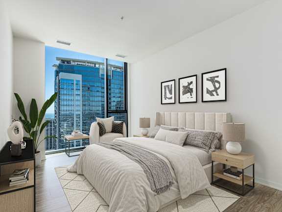A bedroom with a large bed and a view of a cityscape outside the window at One 333, Chicago, Illinois