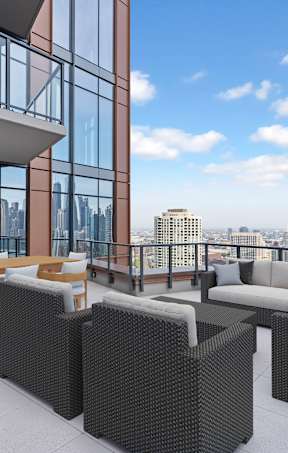 A patio with furniture and a view of the city.