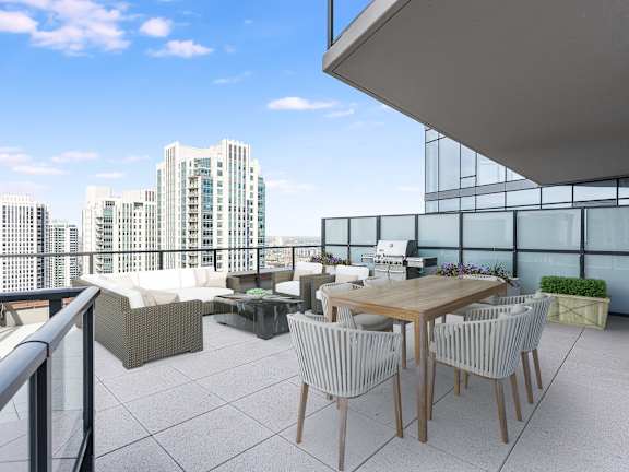 a rooftop terrace with a table and chairs and a view of the city at Cassidy on Canal, Chicago, 60654