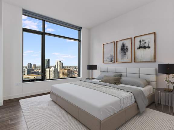 a white bedroom with a large window and a white bed
