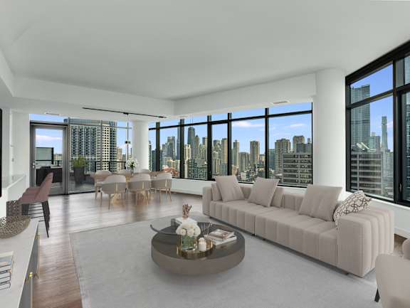 a living room with a white couch and a table and a view of the city