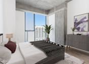 Thumbnail 9 of 21 - A modern bedroom with a large bed and a view of the city at One 333, Chicago, IL