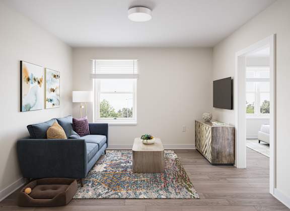 A living room with a blue couch and a rug. at Divinity Landing Apartments, Macedonia, 44056