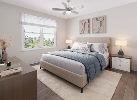 A bedroom with a large bed and a ceiling fan. at Evergreen Heights Apartments, Toledo