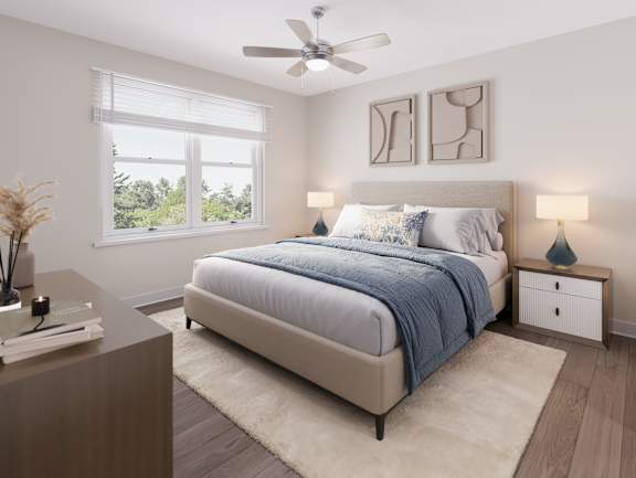 A bedroom with a large bed and a ceiling fan. at Evergreen Heights Apartments, Ohio, 43614