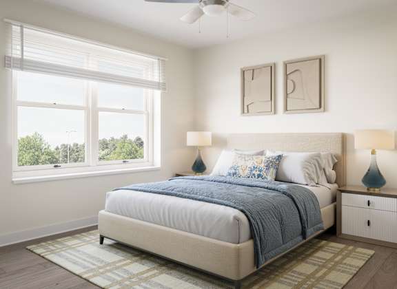 A bedroom with a large bed and a ceiling fan. at Divinity Landing Apartments, Macedonia, 44056