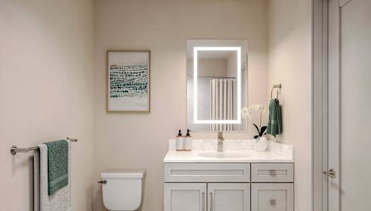 A white toilet sits next to a white sink in a small bathroom.