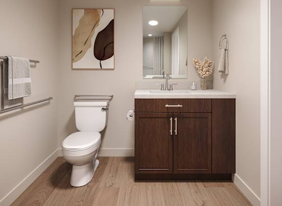 A white toilet sits in a bathroom next to a wooden cabinet. at Oskamp Flats Apartments, Cincinnati, OH