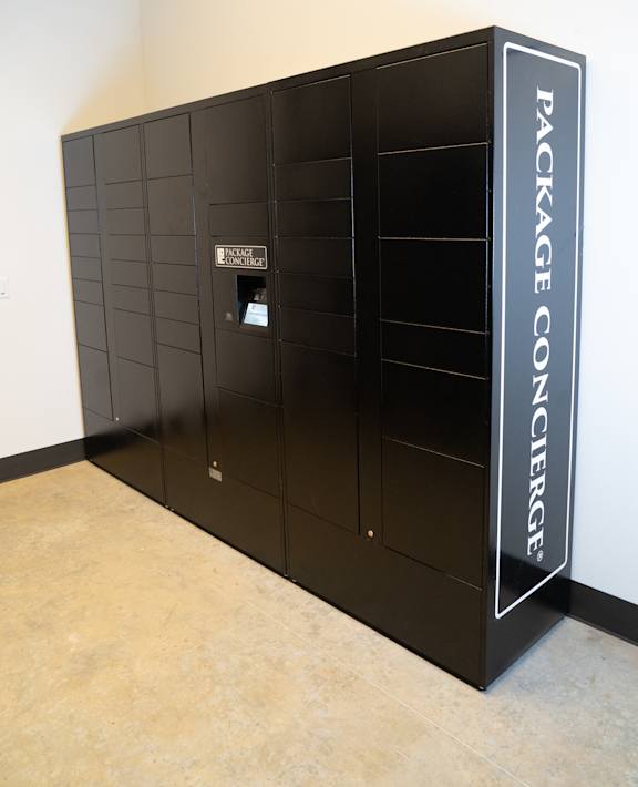 a group of black refrigerators in a room