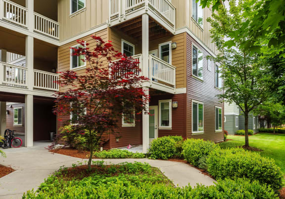 a large apartment building with balconies and a sidewalk