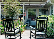 Thumbnail 4 of 5 - two rocking chairs on a patio in front of a house