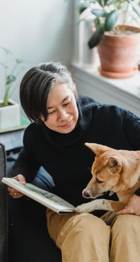 a woman spending time with a dog at 505 Collection in Atlanta, Georgia