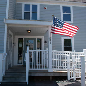 an flag flies in front of a house
