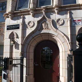 the front of a building with a red door