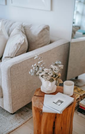 a living room filled with furniture and a large mirror