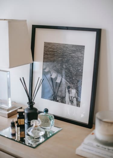 a picture frame on a desk with a picture of a man and a woman on a boat