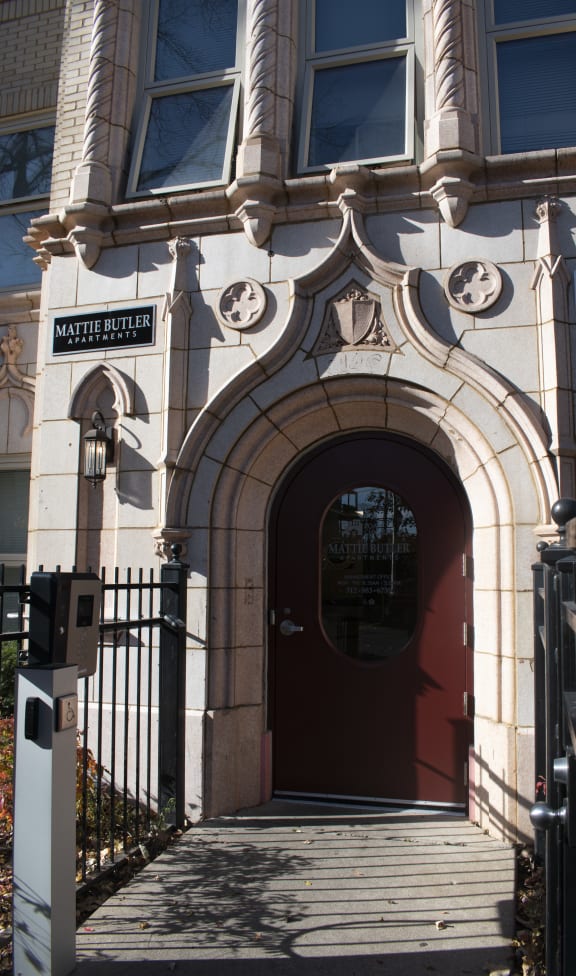 the front of a building with a red door