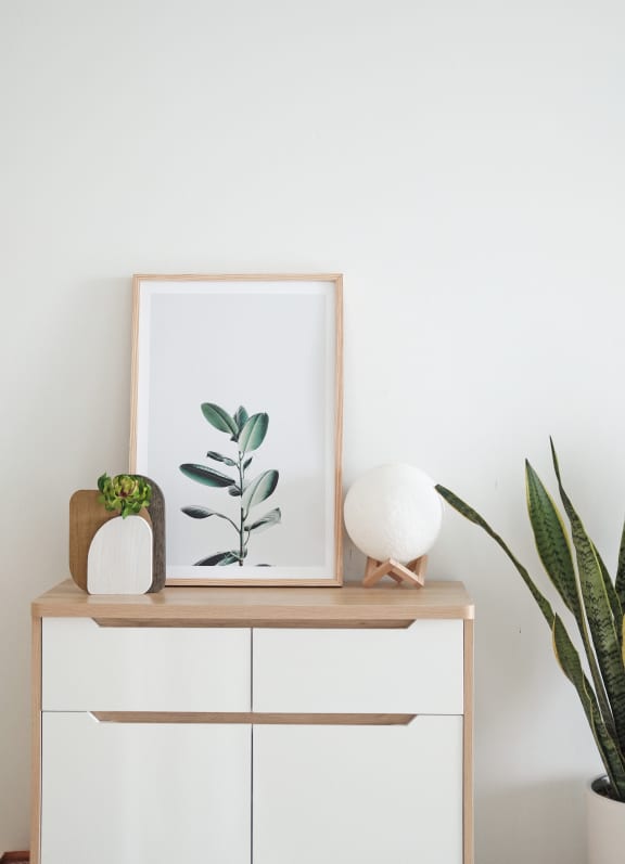 Table with drawers with painting and plant