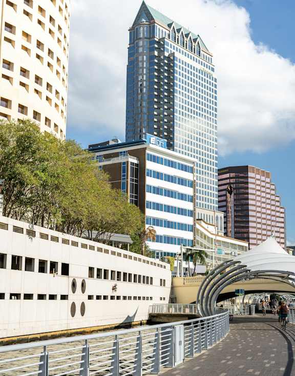A white building with a curved walkway in front of it.