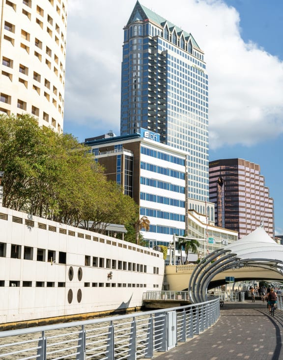 a boat on a river with tall buildings in the background