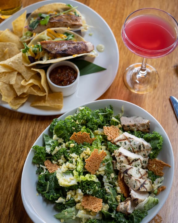 a plate of food and a glass of wine on a table