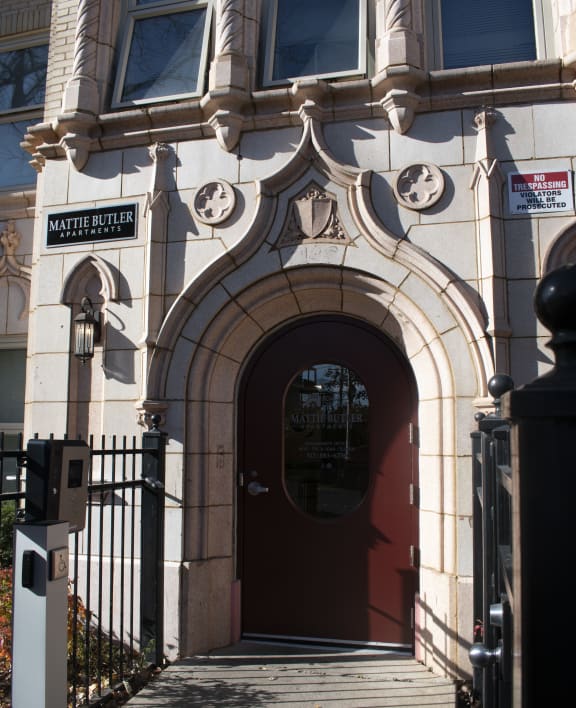 the front of a building with a red door