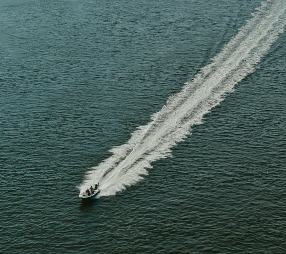 a boat traveling across a body of water