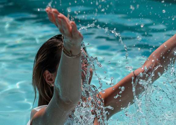 A woman diving into a pool.