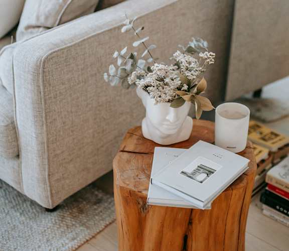 a living room with a couch and a coffee table with a vase of flowers at Woodbriar Management, LLC, Tucker, GA