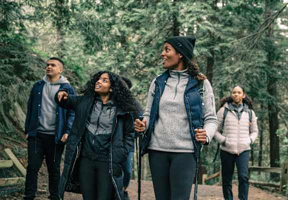 A group of people hiking in a forest.