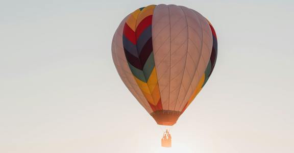 Two hot air balloons float in the sky.