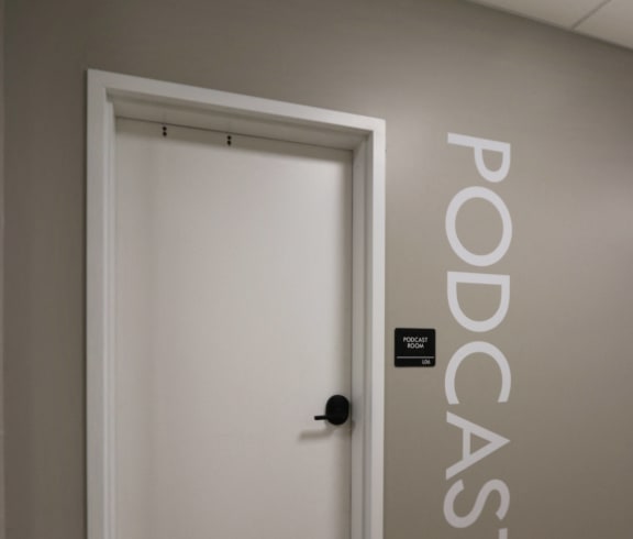 a white door in a hallway with a black door knob