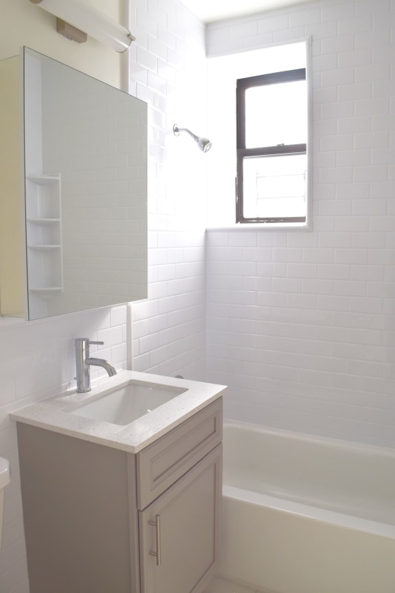 a small bathroom with a sink and a bathtub