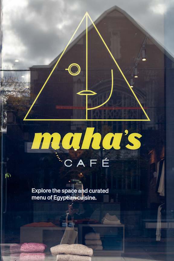 a sign in the window of a cafe with the name maharanis cafe